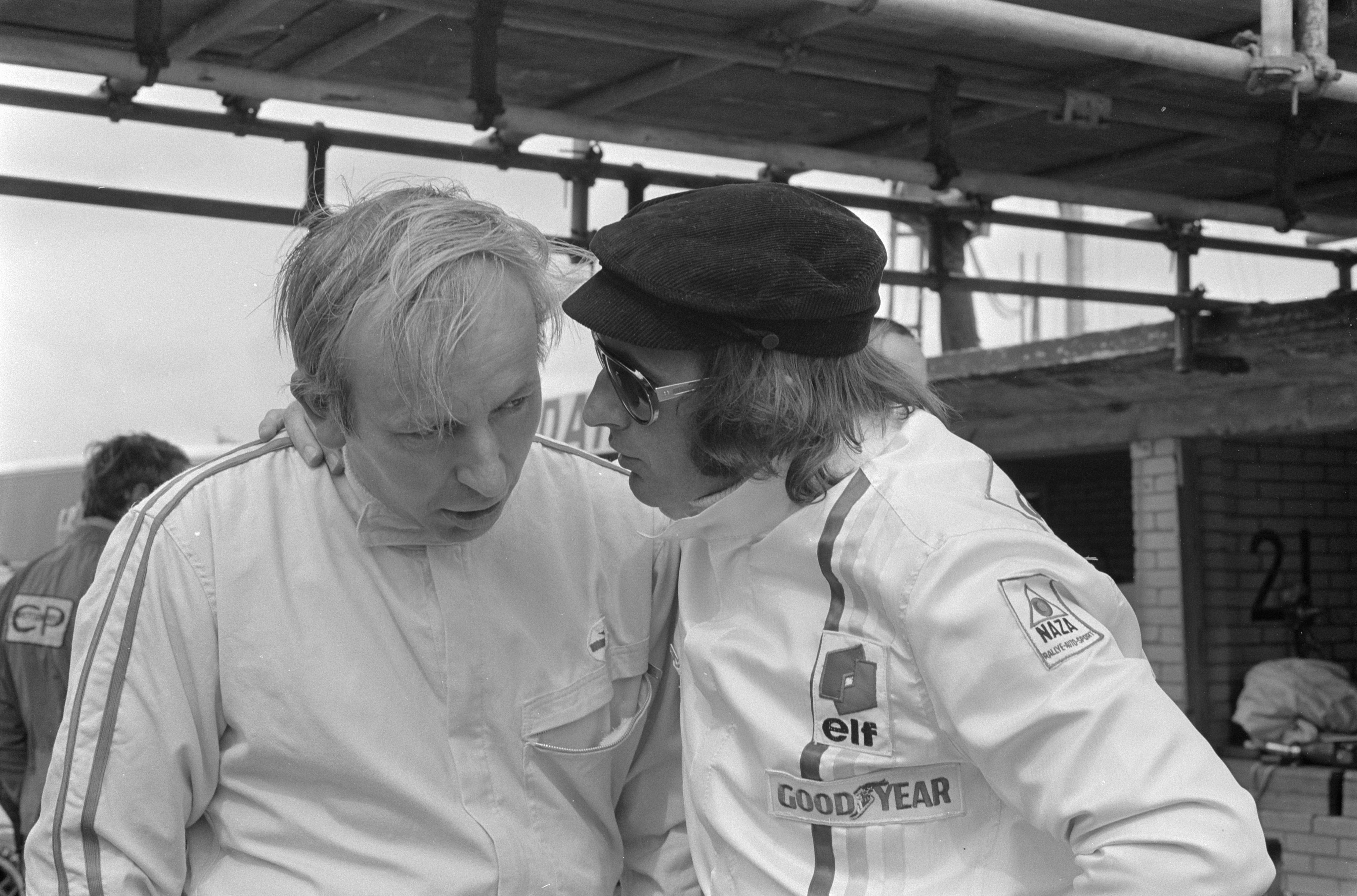 John Surtees on the left talking with Jackie Stewart at Zandvoort in 1971