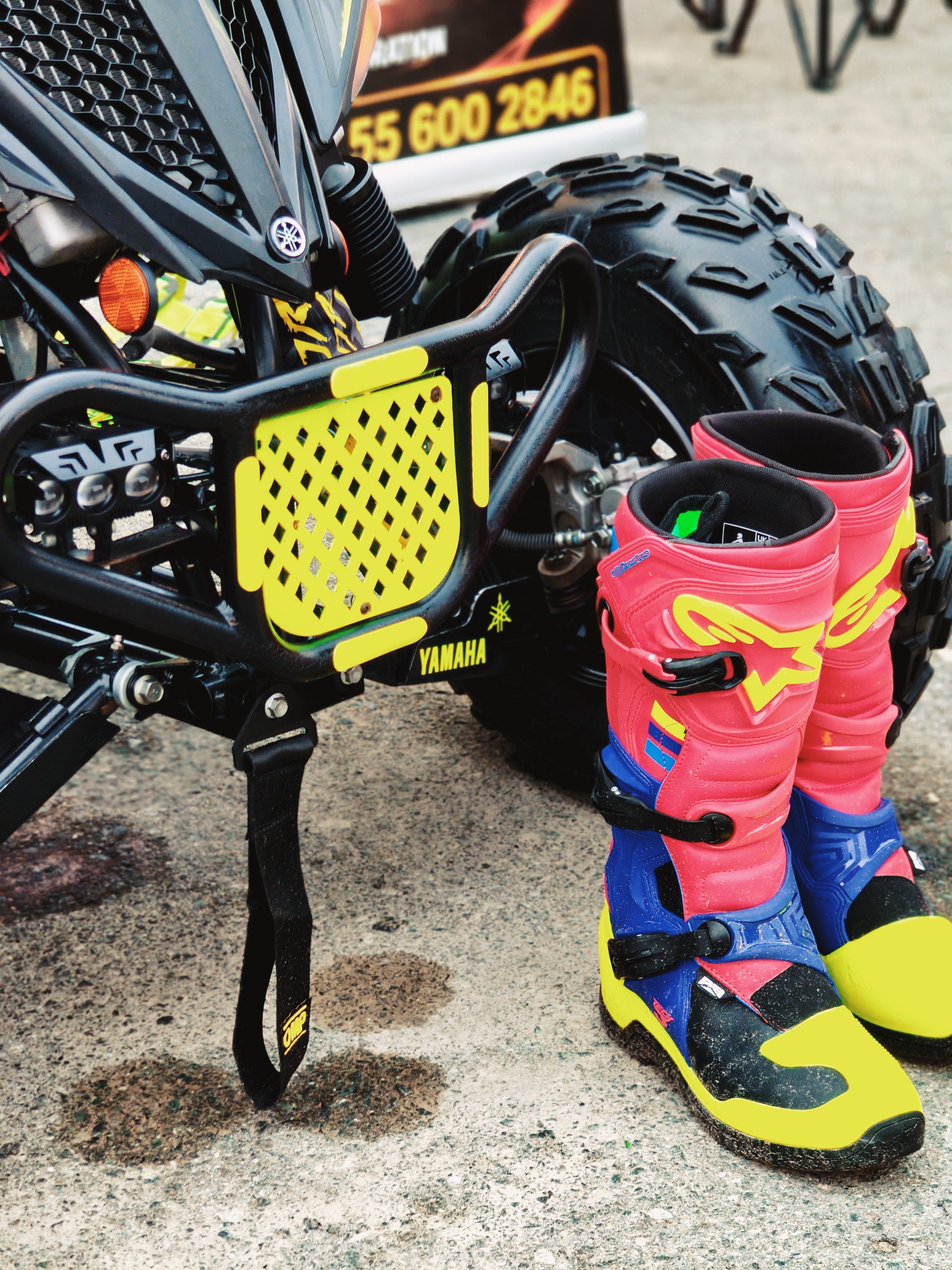 Motocross boots beside an ATV